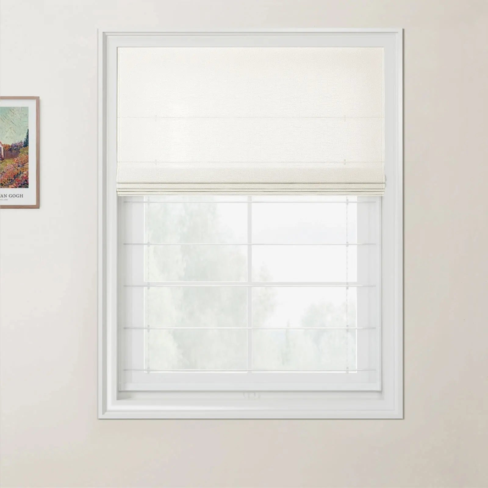 Photograph of a bright room featuring a window with a white frame and a half-drawn off-white linen roman blind above a blurred view of trees, with a framed Van Gogh print on the light beige wall to the left