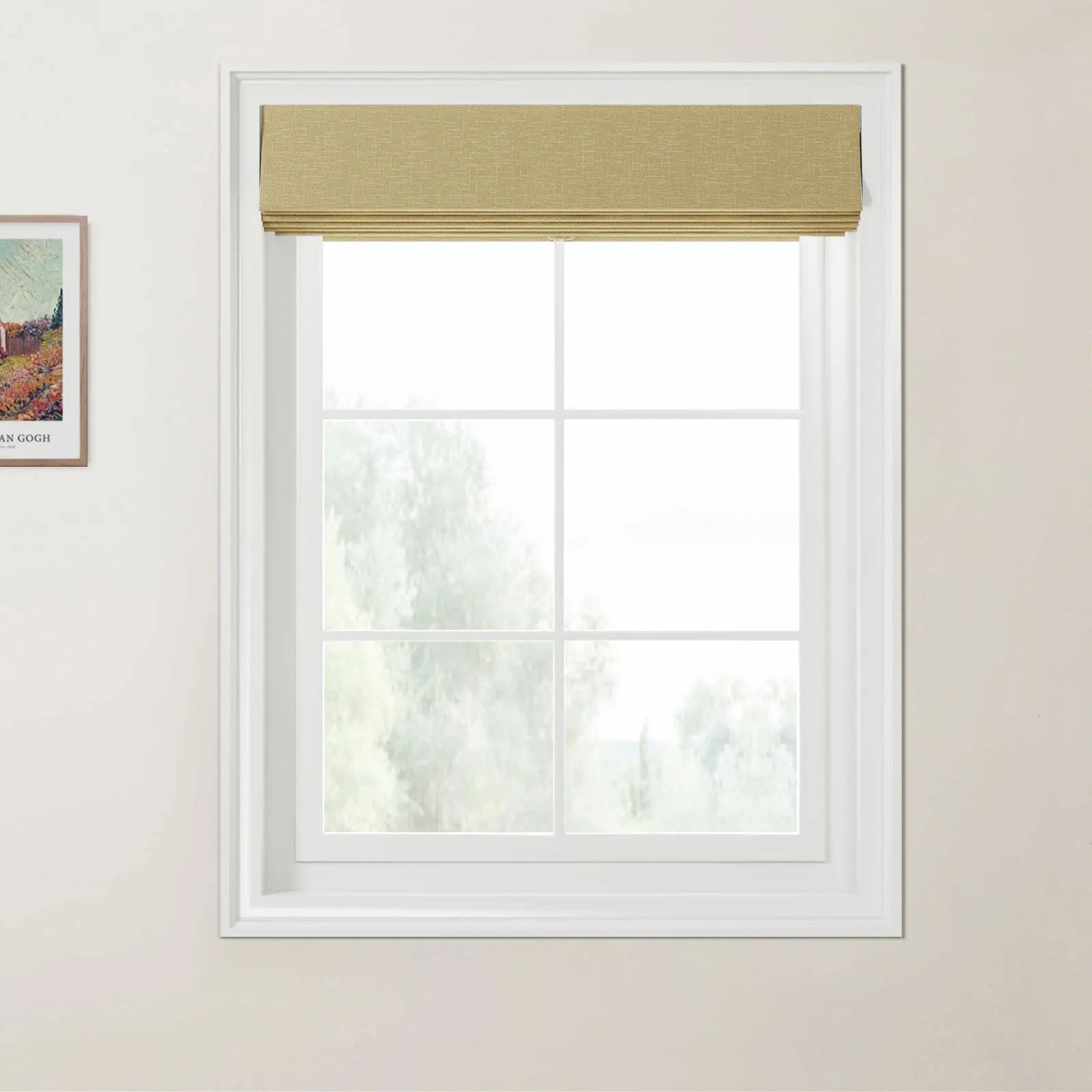 Photograph of a white six-pane window featuring a neatly folded textured golden yellow Roman blind, set against light beige walls with a partial Van Gogh print on the left, looking out to blurred green foliage