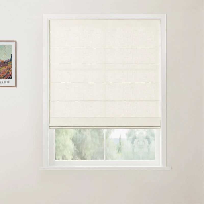 A photograph showcasing a window with a cream textured Roman blind featuring horizontal folds, set in a white frame, overlooking a blurred green landscape, with a framed Van Gogh print on the left wall