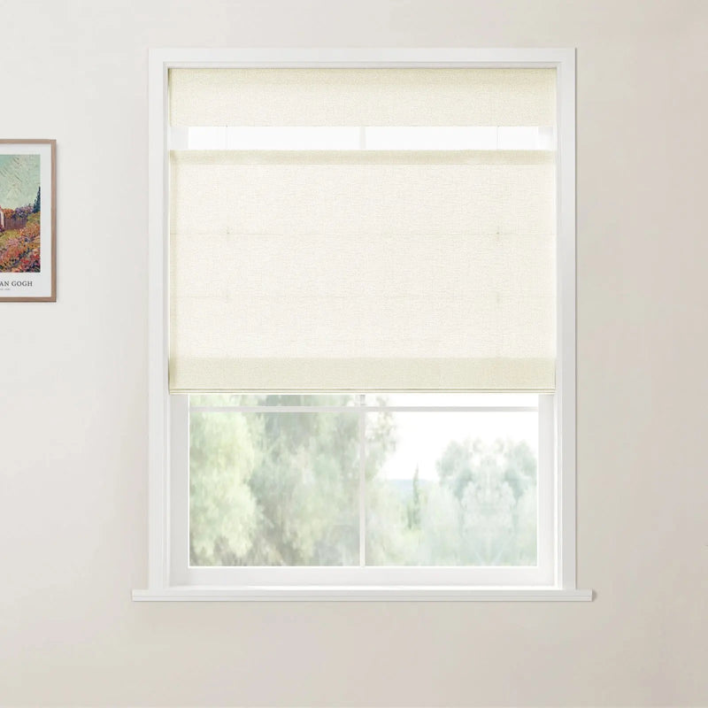 Interior photo of a white-framed window with a cream textured roller blind partially lowered, revealing blurred green trees outside, and a framed Van Gogh landscape print on the adjacent white wall