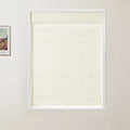Photograph of a window featuring a textured cream Roman blind within a white frame, with a partial view of a framed Van Gogh painting on an adjacent white wall