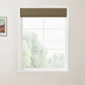 Photograph of a white multi-pane window with a brown Roman blind and a framed Van Gogh art print on a light beige wall looking out to misty green trees