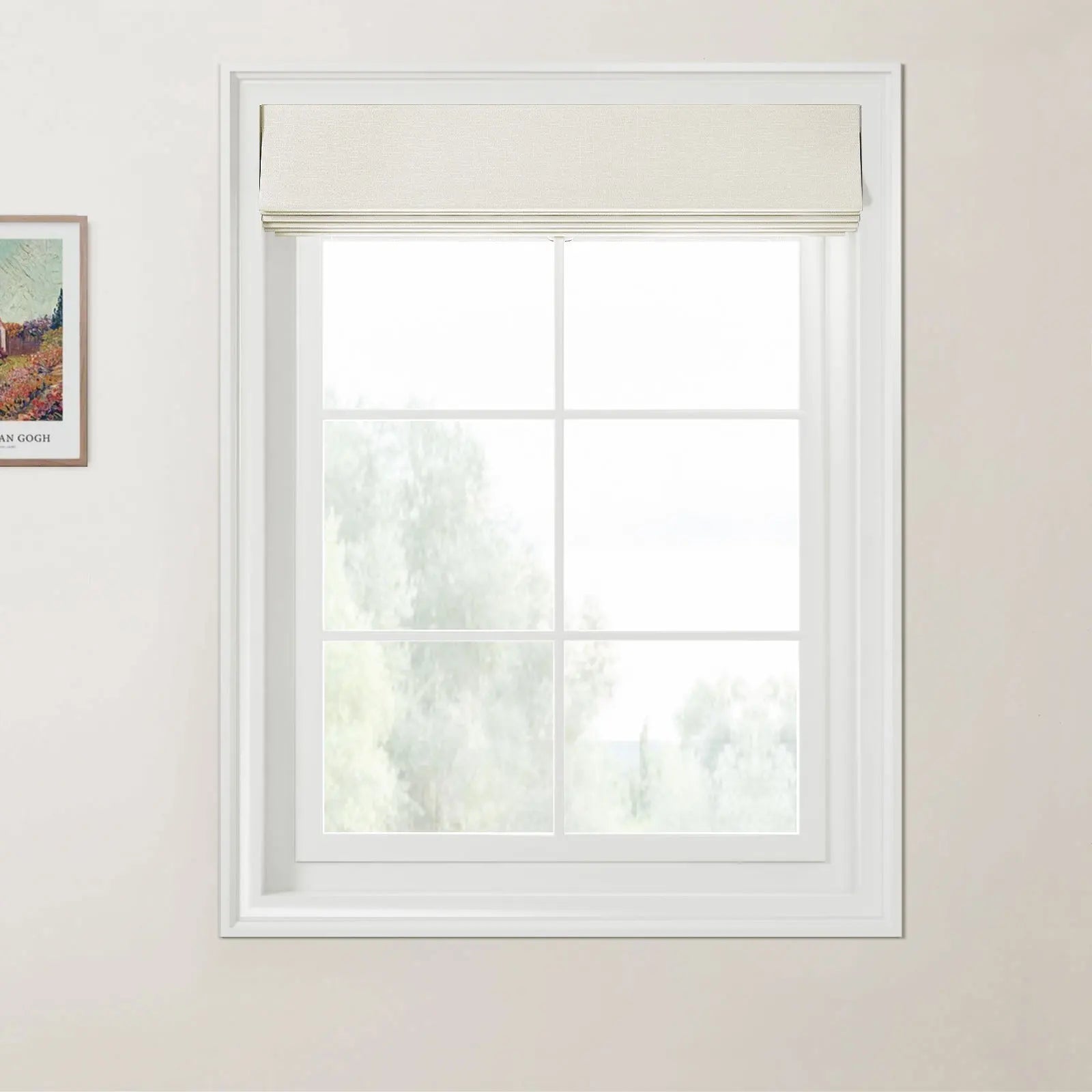 Van Gogh print a framed landscape painting on a light wall next to a white gridded window with a textured beige Roman blind overlooking blurry green trees