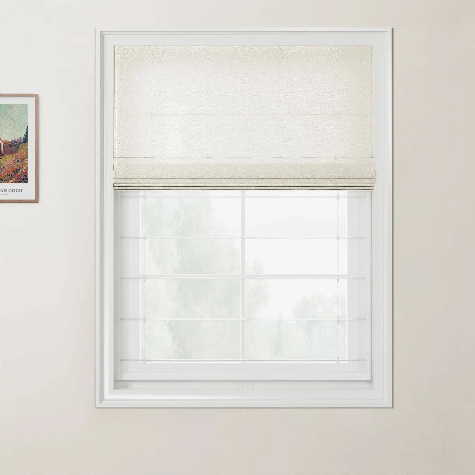 Photograph of a modern interior featuring a cream Roman blind half-closed over a white grid window looking out to blurred green trees, with a framed Van Gogh landscape print on the pale beige wall