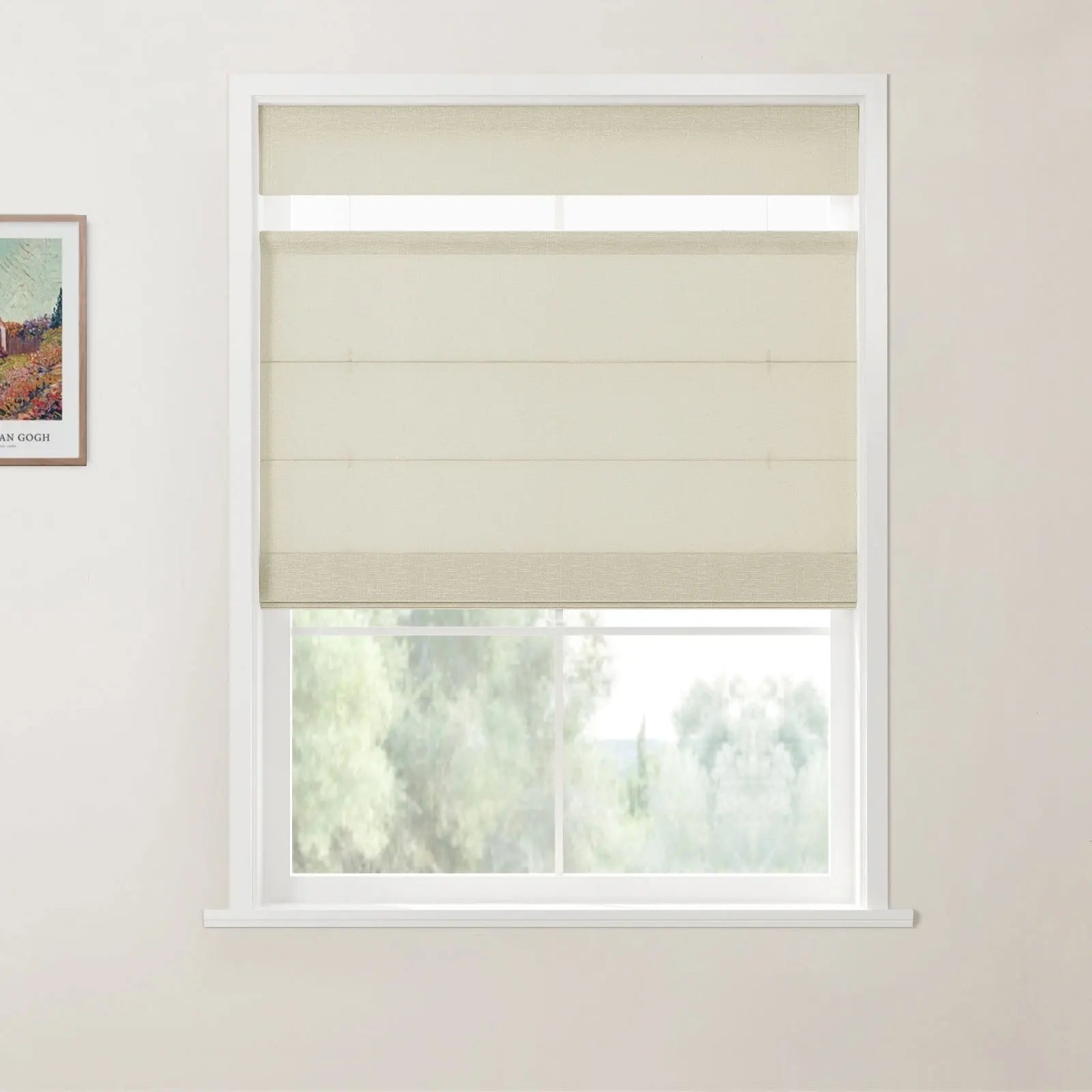 Photograph of cream-colored layered window shades installed on a white window frame, with a partial Van Gogh print visible on the light beige wall and a soft green landscape outside