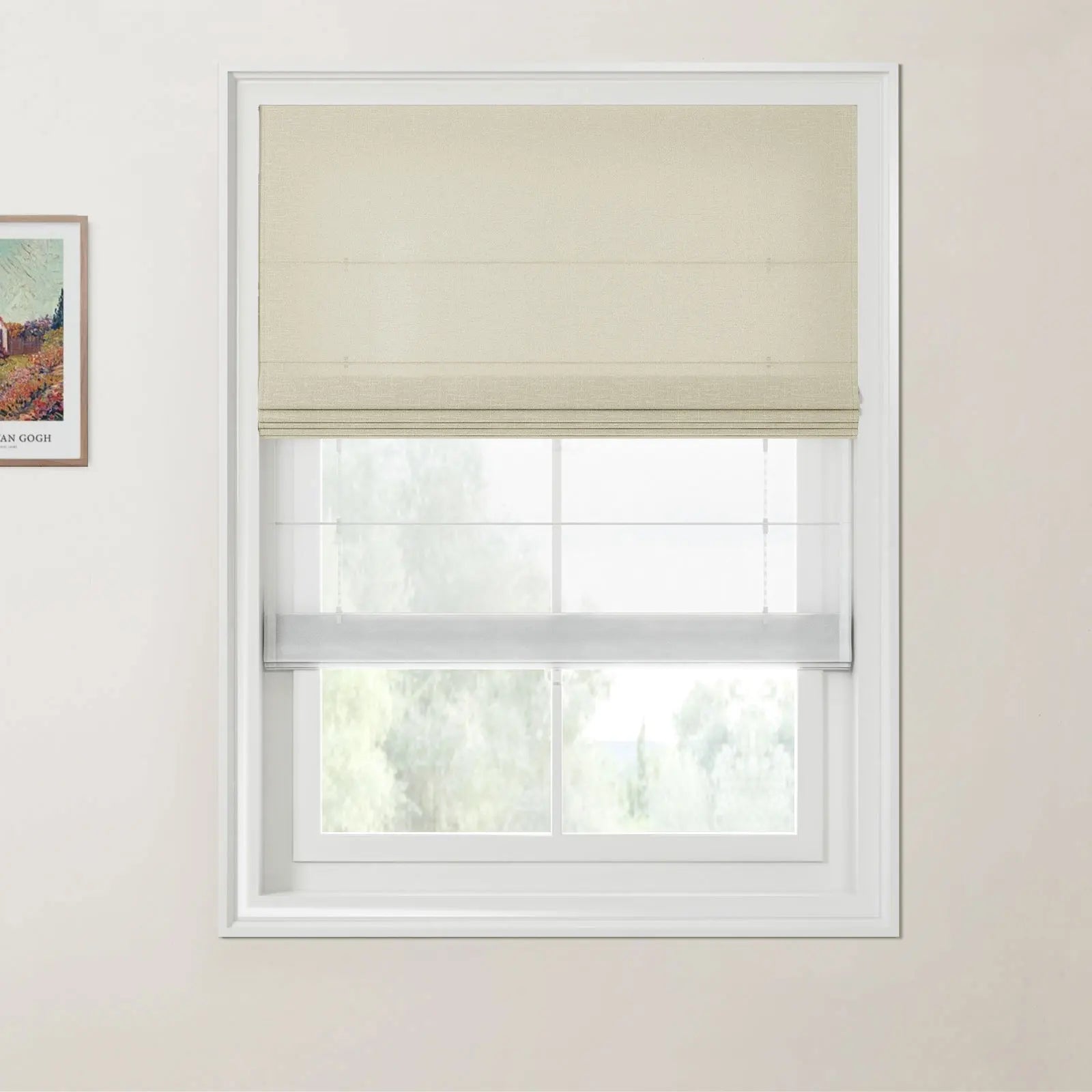 Photograph of a window with a textured beige Roman blind layered over a white sheer blind, revealing a blurred view of green trees, and a framed Van Gogh print on the adjacent left wall