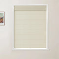 Photograph of a window in an interior room showcasing a textured beige Roman blind with distinct horizontal folds and a matching top valance, set within a white frame, with a partially visible Van Gogh print adorning the adjacent wall