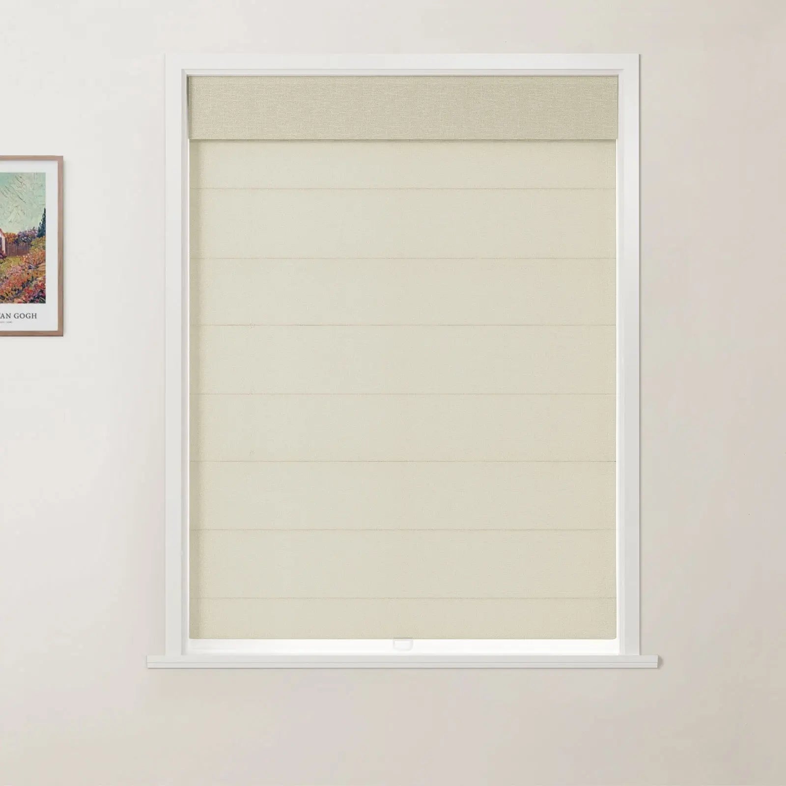 Photograph of a window in an interior room showcasing a textured beige Roman blind with distinct horizontal folds and a matching top valance, set within a white frame, with a partially visible Van Gogh print adorning the adjacent wall