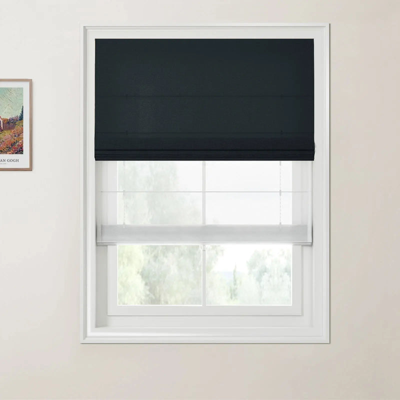 Photograph of a modern home interior featuring a white framed window with dual layered blinds, including a dark grey Roman blind above a sheer white blind, alongside a partially visible framed Van Gogh landscape print on the light beige wall