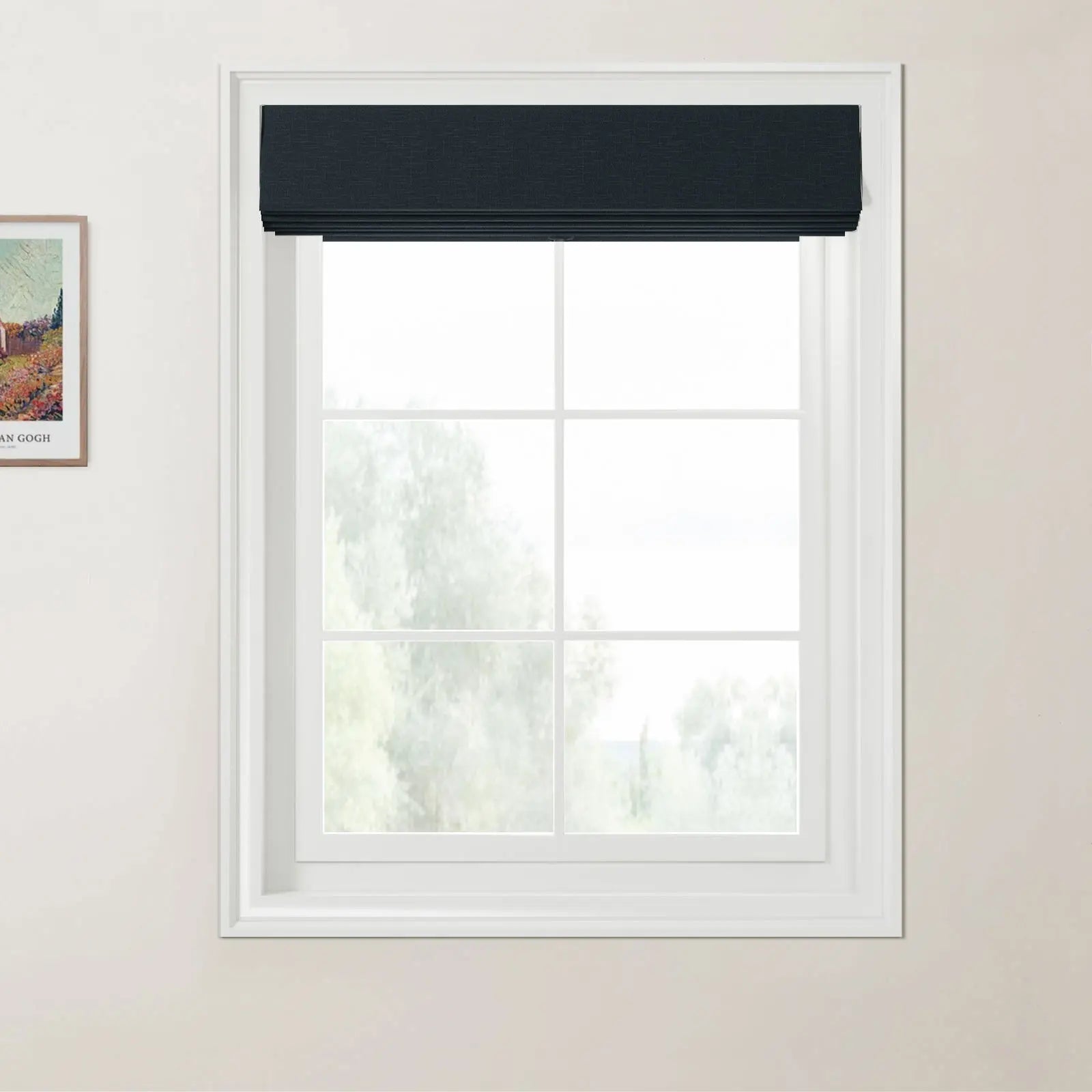 Photograph of a white multi-pane window with a dark navy blue textured Roman blind and a framed Van Gogh print on the adjacent light beige wall, offering a blurred view of green trees outside