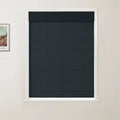 Photograph featuring a framed Van Gogh print in a room with a window displaying a dark textured horizontal blind, set within a white frame against an off-white wall