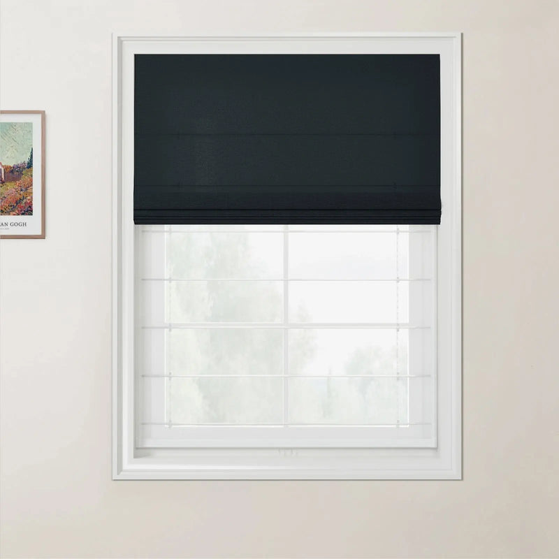 Photograph featuring a dark grey roman blind covering part of a white grid window in a room, with a framed Van Gogh print on the left wall