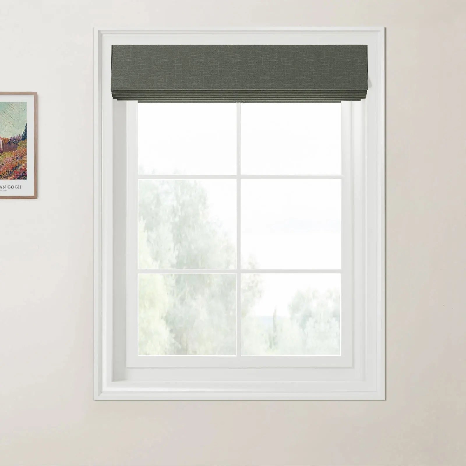 Photograph of an interior window featuring a dark green textured Roman blind above a white multi-pane window frame looking out to a hazy green natural landscape, with a framed Van Gogh print depicting colorful fields on the adjacent light beige wall