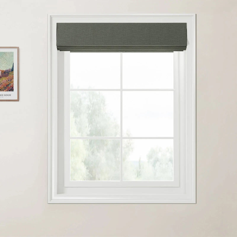 Photograph of an interior window featuring a dark green textured Roman blind above a white multi-pane window frame looking out to a hazy green natural landscape, with a framed Van Gogh print depicting colorful fields on the adjacent light beige wall