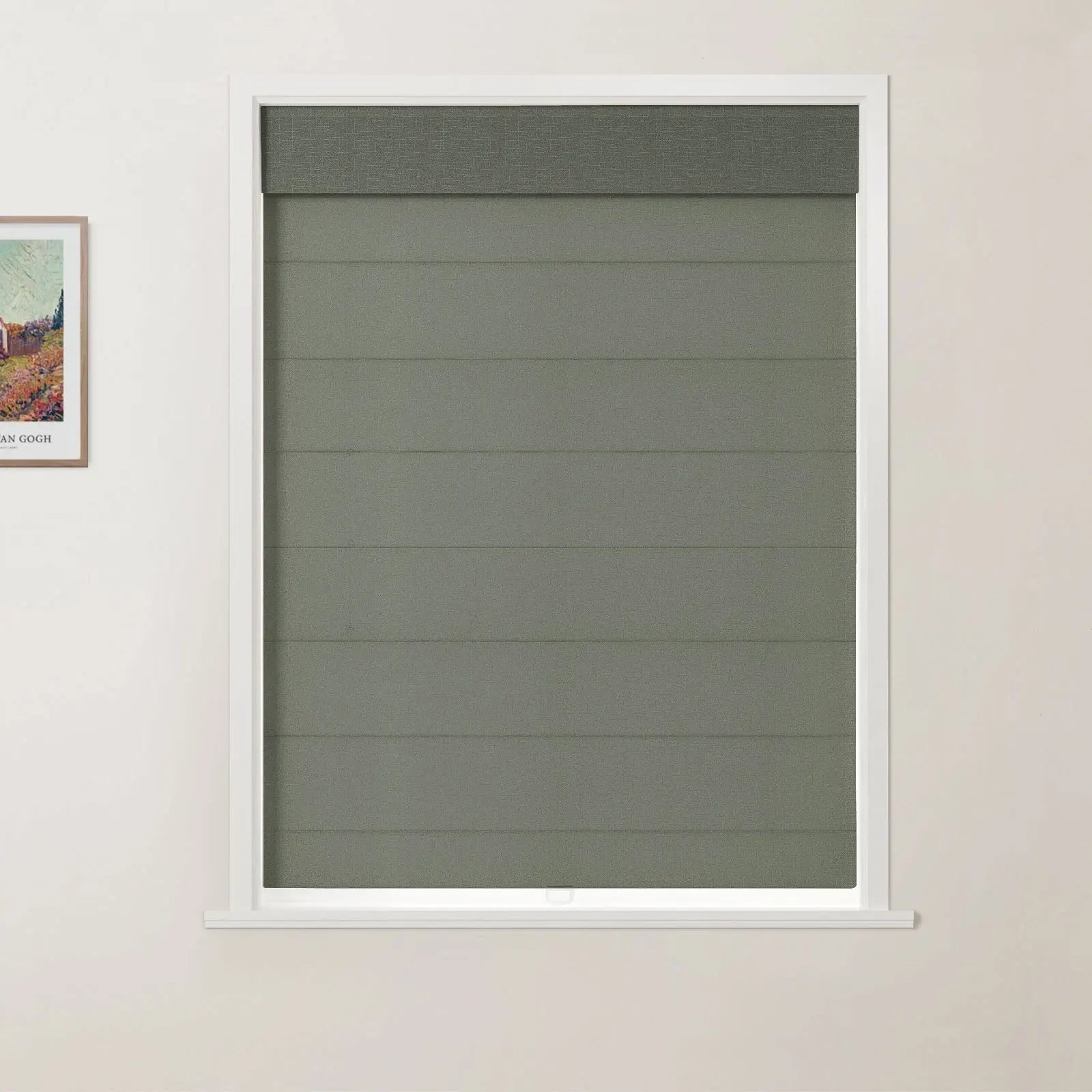 Photograph showing a modern interior with a white-framed window featuring a textured dark olive green Roman blind with horizontal folds and a darker top valance, positioned next to a framed vibrant Van Gogh print on a light cream wall