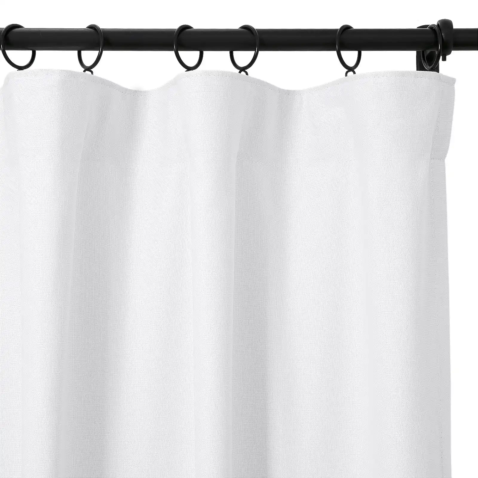 A white textured fabric curtain with soft vertical folds hangs from a black metal rod secured by black rings