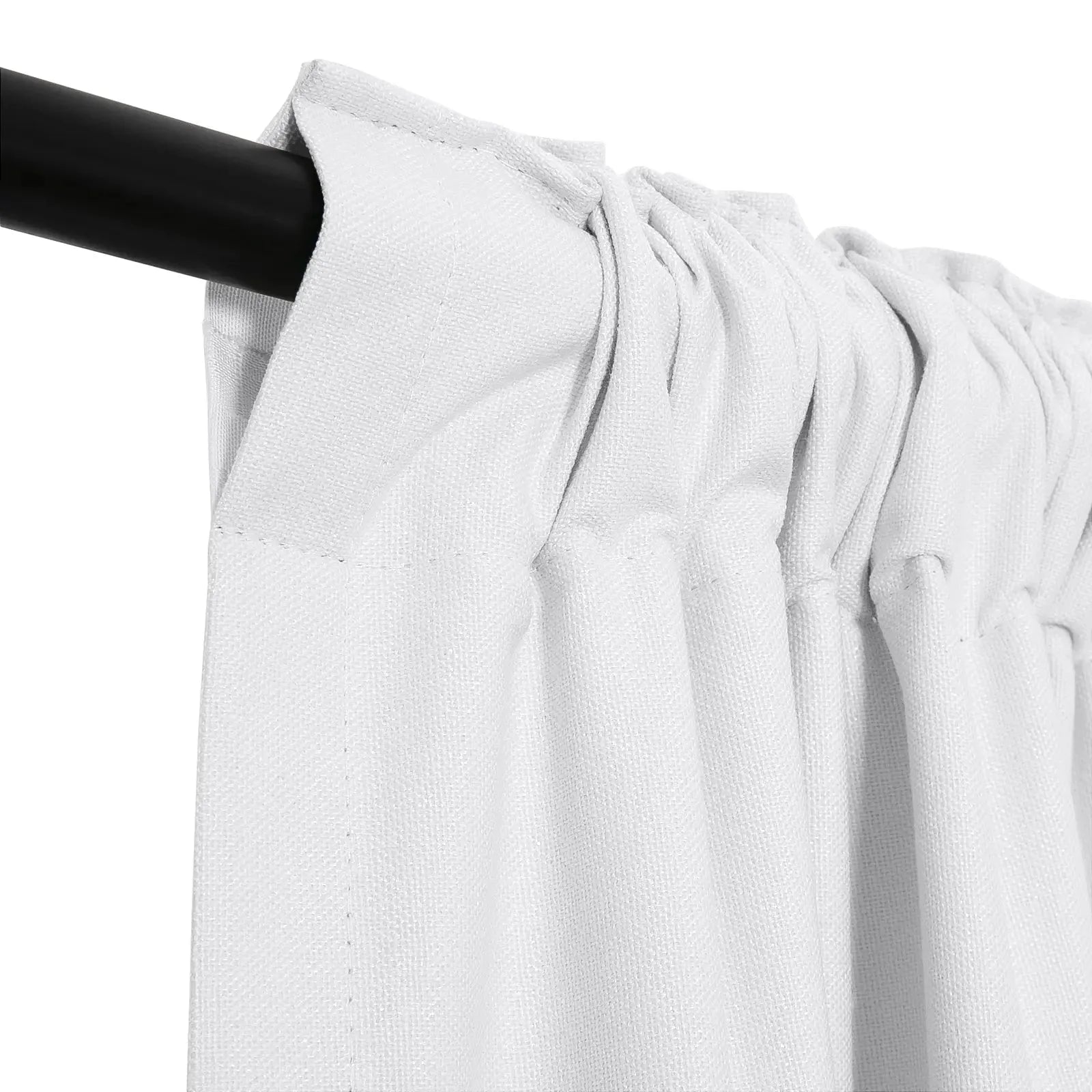 A white textured fabric curtain with a rod pocket header hangs on a black curtain rod showing gathered pleats