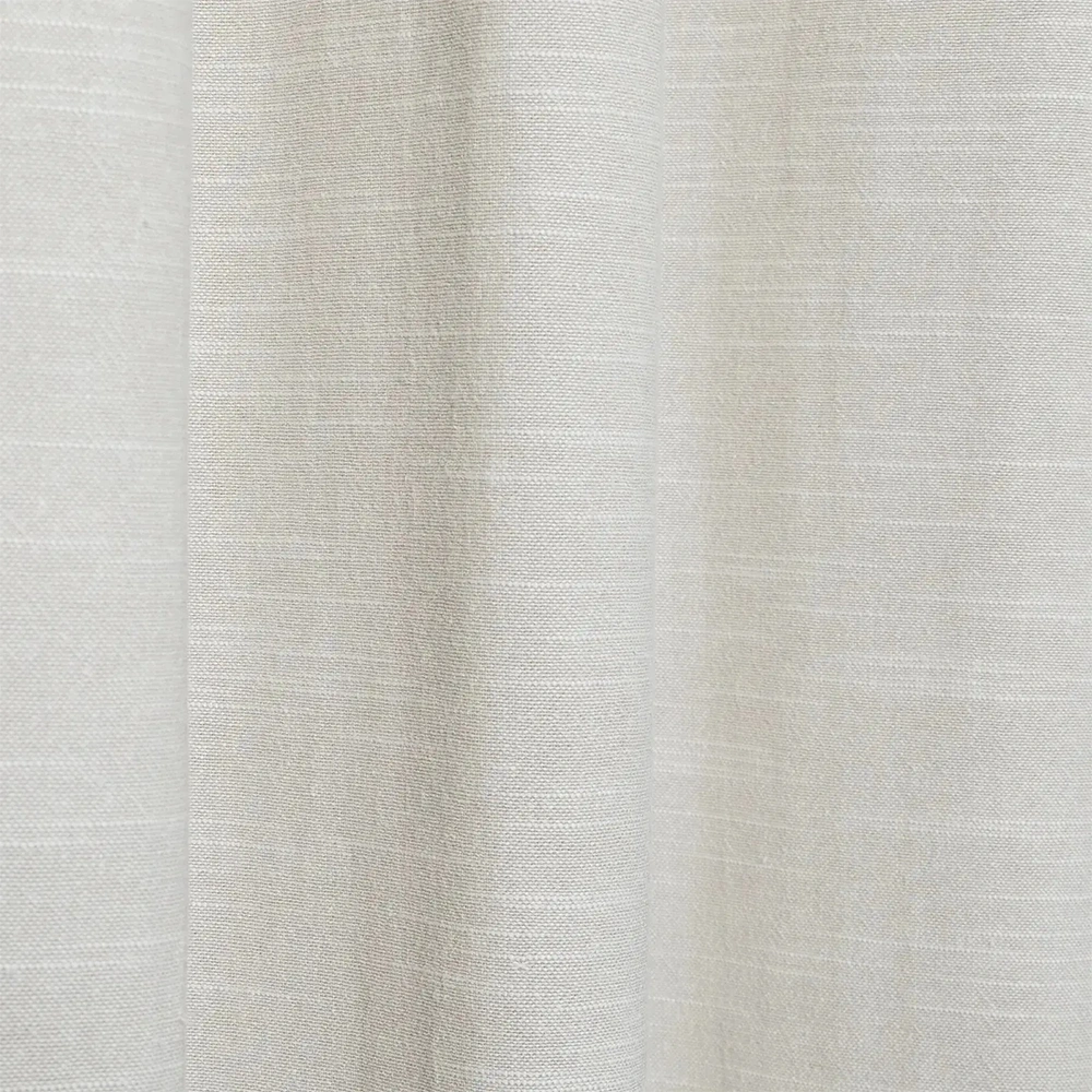 Close-up photograph of a light beige sustainable linen and cotton blend fabric showcasing a subtle textured weave and the text 100% Sustainable with a leaf icon