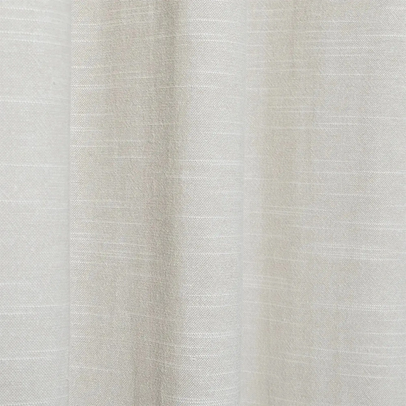 Close-up photograph of a light beige sustainable linen and cotton blend fabric showcasing a subtle textured weave and the text 100% Sustainable with a leaf icon
