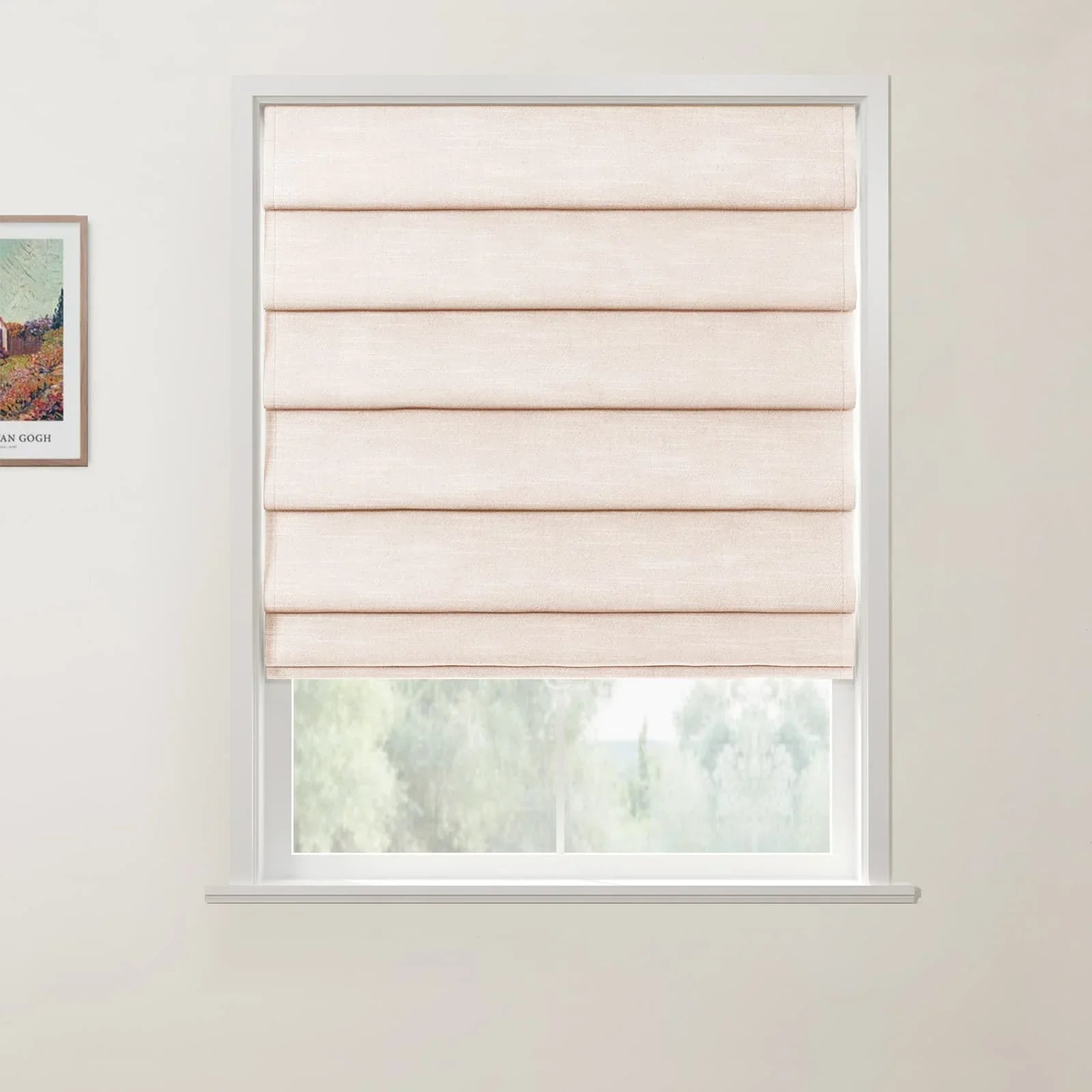 Photograph of a natural linen pleated Roman blind covering the upper part of a white window, revealing blurred green foliage outside, with a framed colorful Van Gogh landscape print on the adjacent light wall