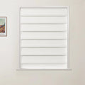 Photograph of white layered cellular blinds covering a window on a light beige wall, with a partially visible framed colorful Vincent van Gogh landscape print on the left
