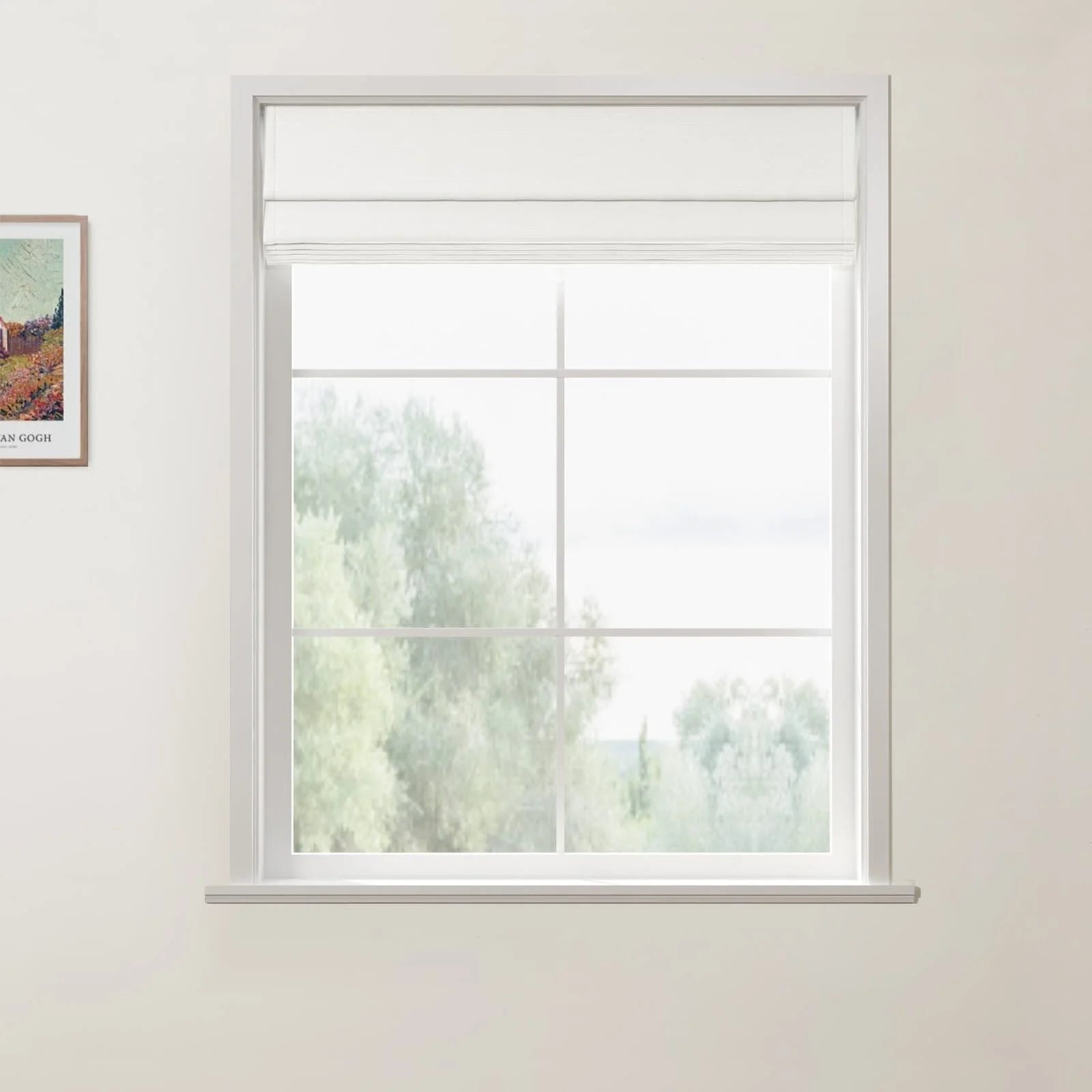 Photograph of a white-framed window with a partially lowered white Roman blind and grid panes, offering a soft view of blurred green trees, next to a framed Van Gogh print on a white wall