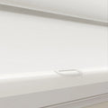 Modern white textured day-night roller blind featuring a clear plastic finger pull handle and white bottom rail