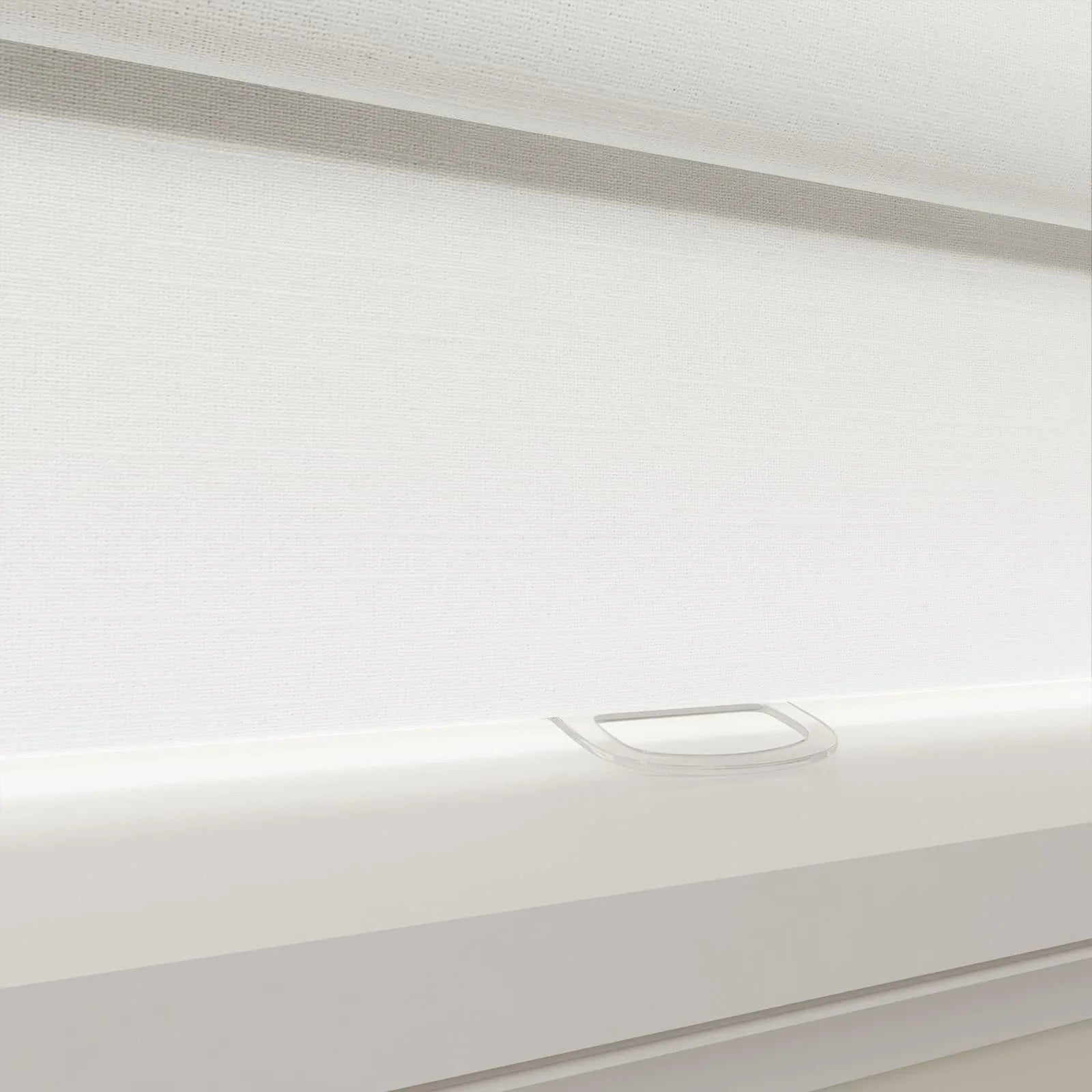 Modern white textured day-night roller blind featuring a clear plastic finger pull handle and white bottom rail