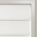 White textured cellular blinds covering a window within a bright white frame featuring soft horizontal pleats