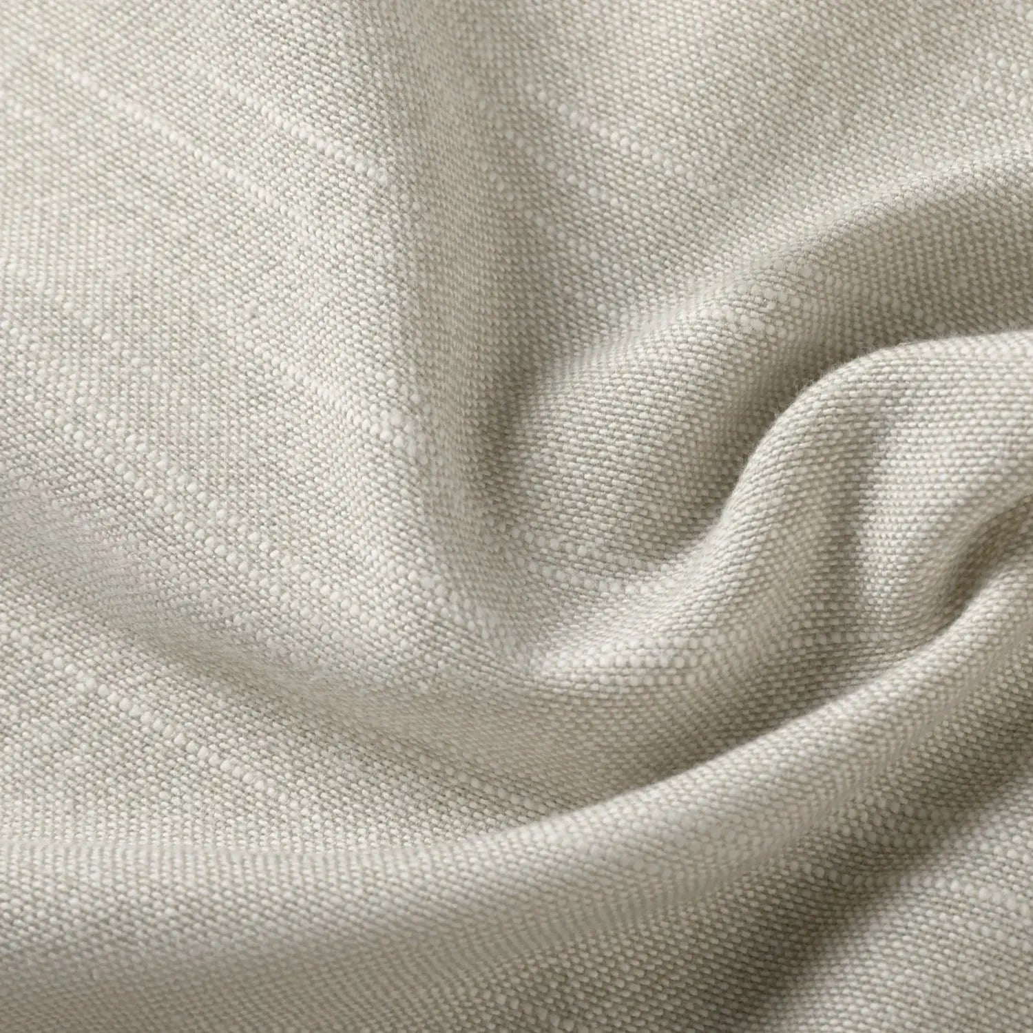 Light grey-beige fabric displaying an intricate slub weave with soft gentle folds