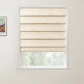 A framed Van Gogh landscape print and a white window with cream textured Roman blinds, revealing blurred green foliage outside a neutral room