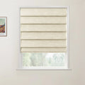 Photograph featuring a framed Van Gogh print showing a colorful landscape, alongside a window with a textured beige Roman blind partially raised to reveal blurred green trees outside against a plain white interior wall