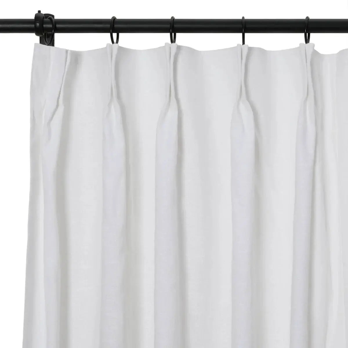 Close-up photograph of a white, softly textured curtain with tailored pleats suspended from a black metal rod using black rings