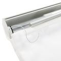 Close-up of a modern white textured roller blind mechanism with a silver aluminum housing and a thin white control cord showing a black end cap