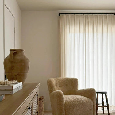 Ron Linen Cotton Herringbone Pleated Curtains - Ice curtains filtering soft daylight in a neutral sitting room with a boucle armchair