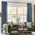 Aegean Blue Liz linen curtains framing a bright window in a balanced full-length interior view