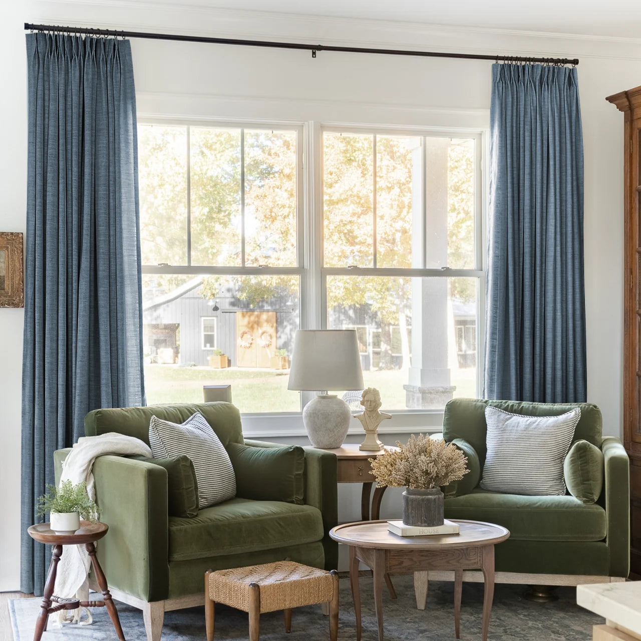 Aegean Blue Liz linen curtains framing a bright window in a balanced full-length interior view