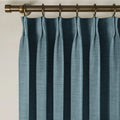 Aegean Blue Liz linen curtains viewed at an angle in a softly styled room with natural daylight