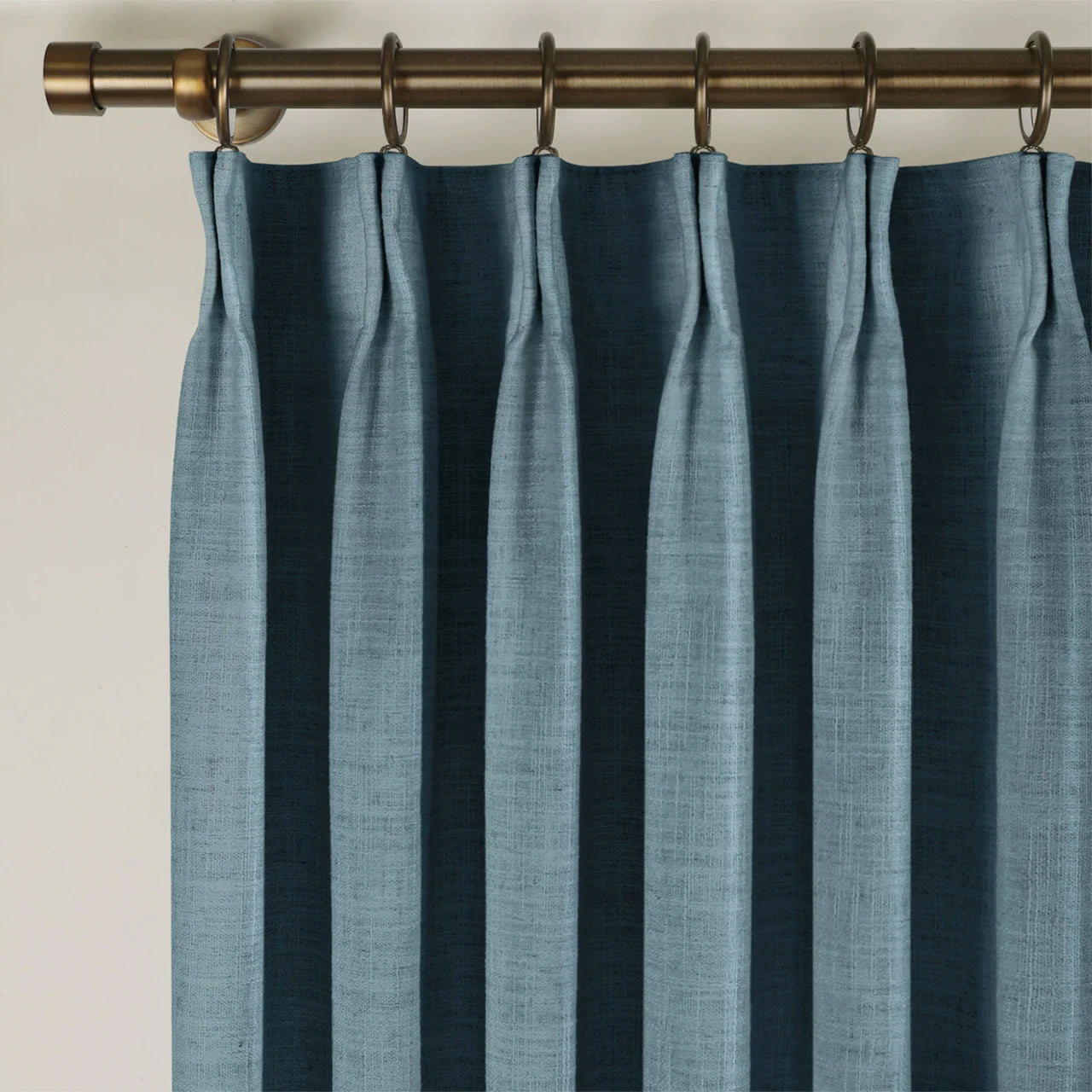 Aegean Blue Liz linen curtains viewed at an angle in a softly styled room with natural daylight
