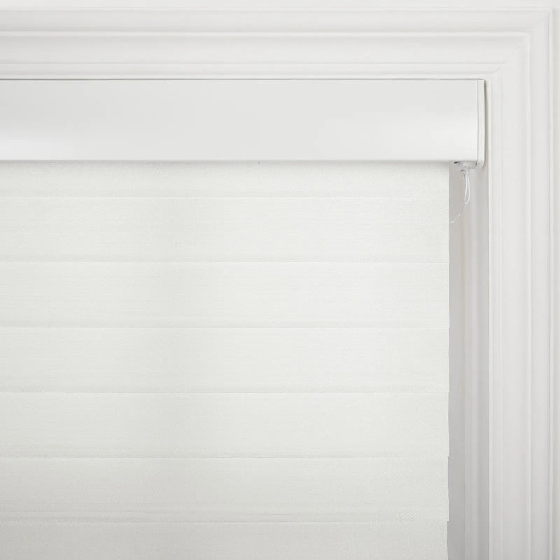 White fabric zebra roller Blind with alternating sheer and opaque horizontal strips hanging inside a white window frame with decorative molding and a control cord on the right