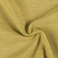 Photograph of a muted chartreuse-colored woven fabric displaying a distinct nubby texture and soft, natural drapes