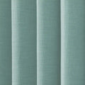 Textured fabric displaying vertical folds in a pale teal color with a woven bouclé texture and subtle light and shadow