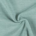 Mint green textured fabric with a bouclé-like weave draped in soft folds and subtle shadows