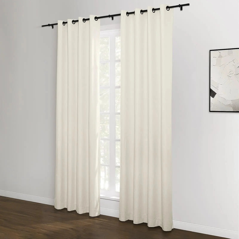 Photograph of off-white grommet top curtains in a modern room featuring a black curtain rod rich dark wood floor and minimalist abstract artwork