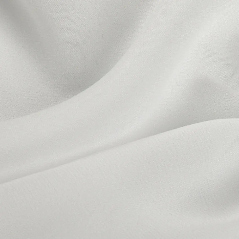 Photograph of white draped fabric featuring elegant undulating folds and a finely textured surface