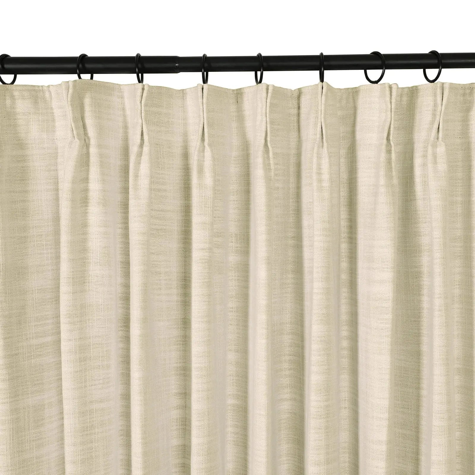 Photograph of a light beige textured linen-look pinch pleat curtain hanging from a black curtain rod with rings