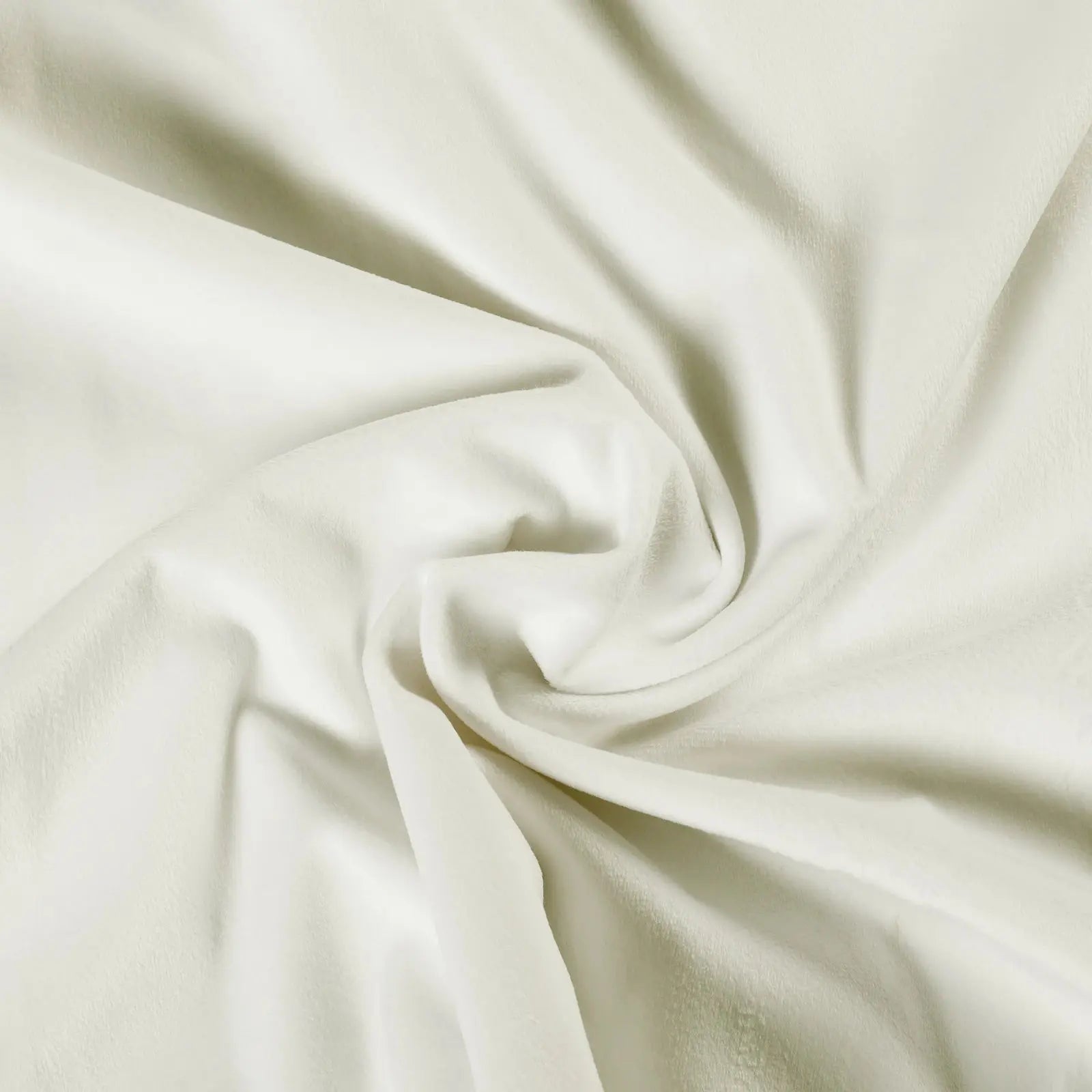 Cream colored soft fabric with gentle swirls and subtle shadows highlighting its plush texture