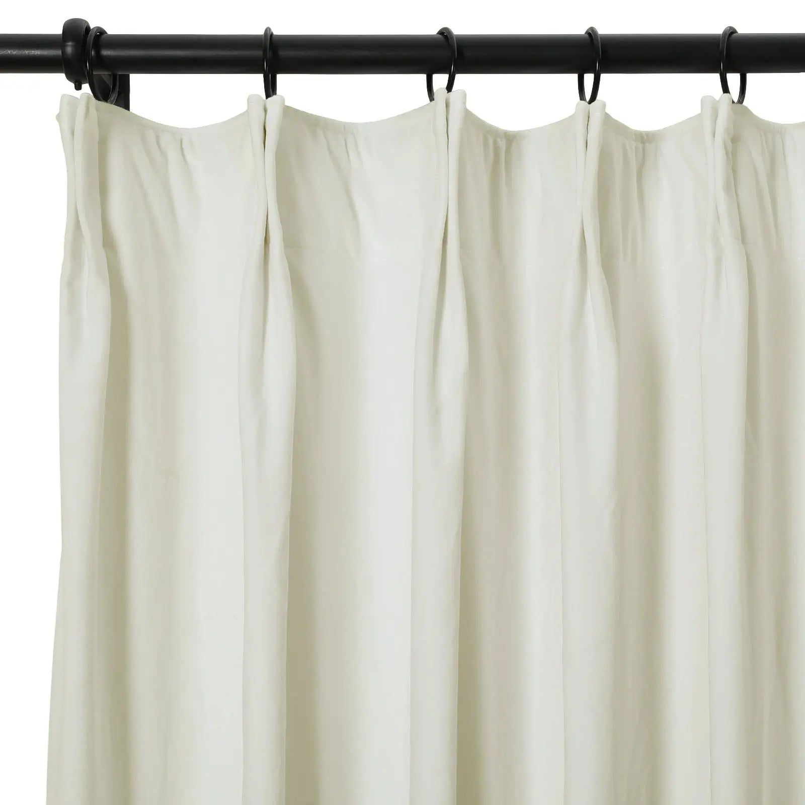 Off-white pleated fabric curtain hanging from black rings on a sleek black metal rod against a clean white background