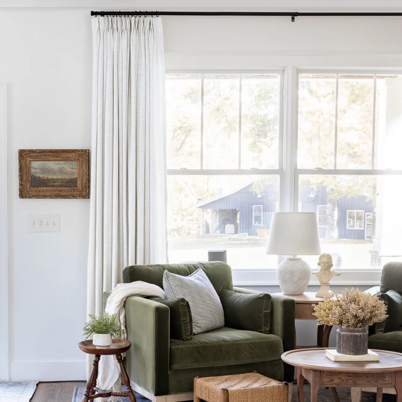 Beige White Liz Linen Pleated Curtains beside a green sofa and dried-flower coffee-table arrangement