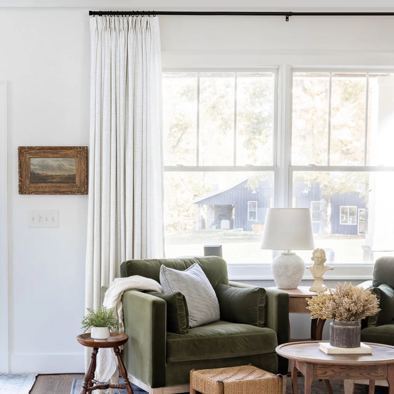 Beige White Liz Linen Pleated Curtains beside a green sofa and dried-flower coffee-table arrangement